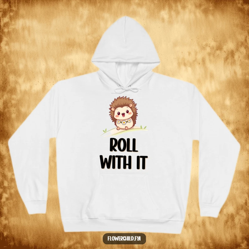 Funny cozy hoodie showcasing a happy hedgehog with a daisy chain, rolling playfully down a soft green hill.