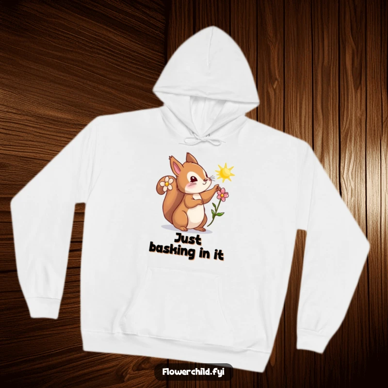Funny squirrel hoodie, a curious squirrel with a flower behind its ear reaching for a sunbeam, symbolizing peace and nature's embrace.